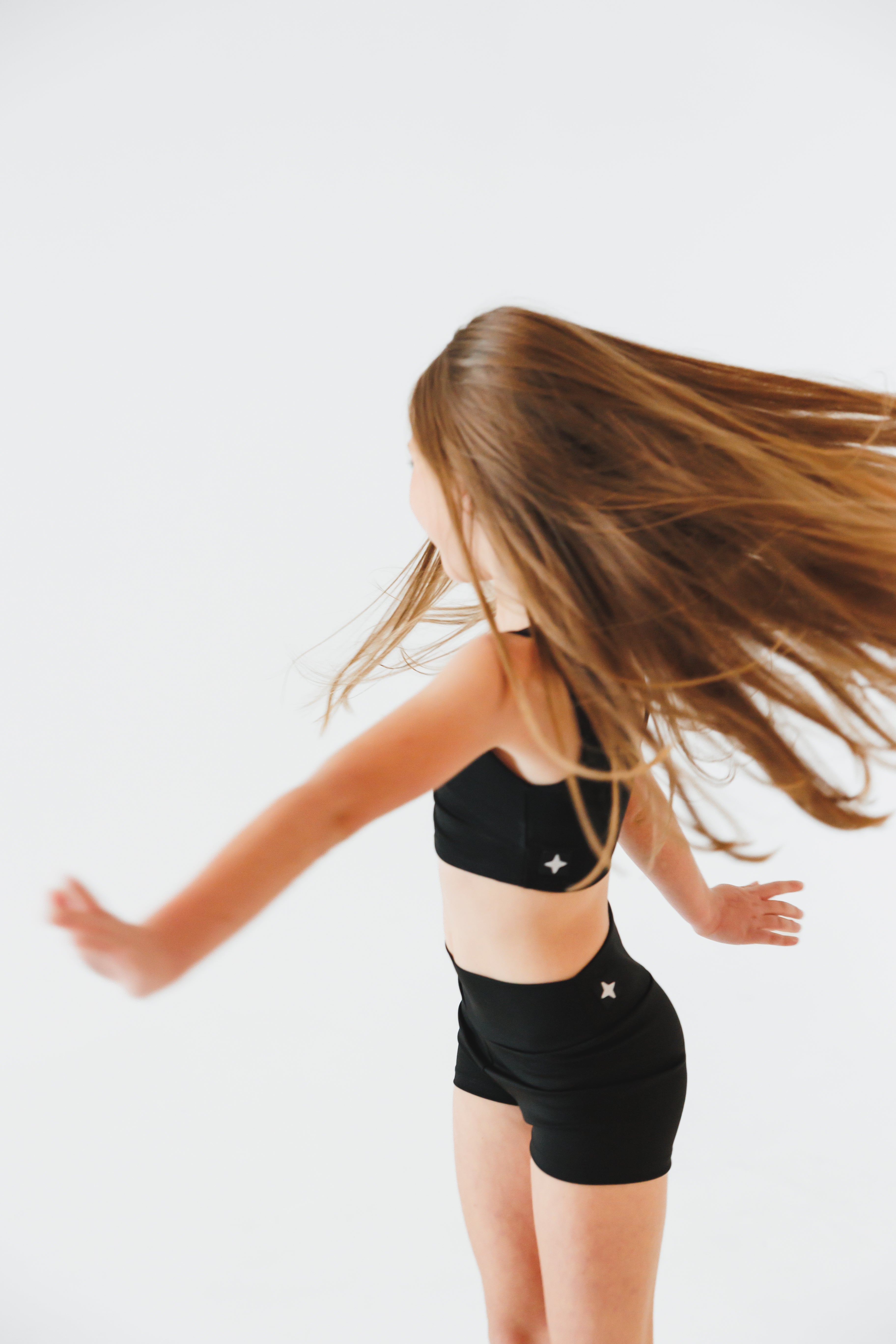 Person wearing a black outfit with star designs on a white background